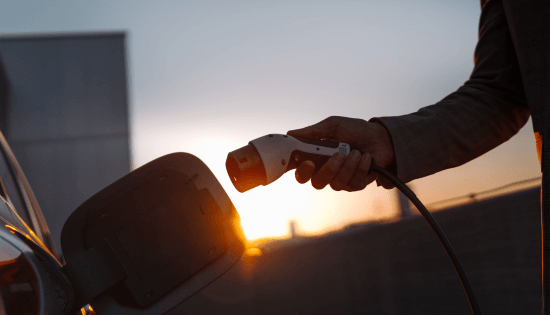 Man charging electric vehicle